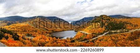 Autumn panorama of a mountain lake. Mountain lake in autumn. Autumn lake in mountains. Mountain lake autumn panorama
