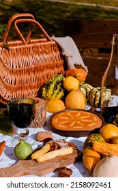 Autumn picnic. Table prepared for lunch in autumn nature, picnic . Harvest, autumn lunch, Wine and glasses. Outdoor meeting