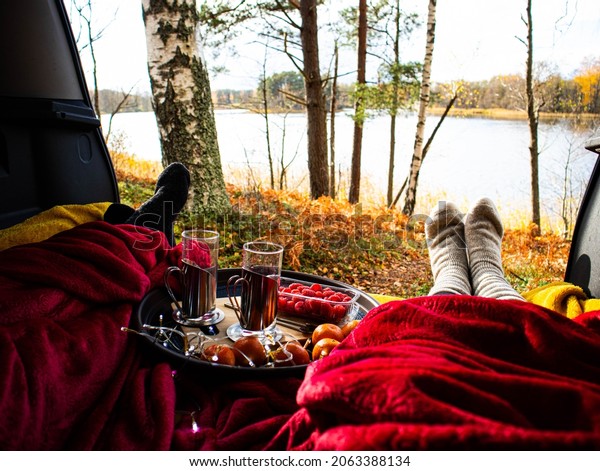 Autumn picnic in\
the trunk of a car by the\
lake