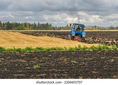 Autumn plowing of land on agricultural fields by a tractor with a plow. Plowing before winter increases the yield of grain crops and improves the soil. Agriculture technologies. Russia, Ural