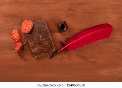 Autumn Poetry. A Photo Of An Old Book With A Thorny Branch With Vibrant Leaves, An Ink Well, And A Quill, Shot From Above On A Dark Wooden Background With Copy Space