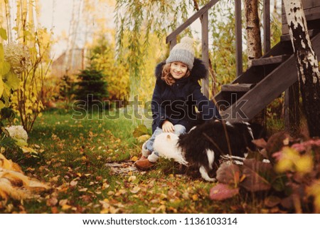 Similar – Foto Bild Herbstporträt eines glücklichen Kindes Mädchens, das mit ihrem Hund spielt.