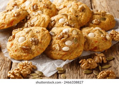 Autumn pumpkin cookies with white chocolate, nuts and seeds close-up on parchment on a wooden table. Horizontal
 - Powered by Shutterstock