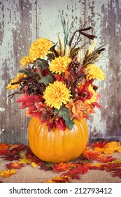 Autumn Pumpkin Flower Arrangement Centerpiece, Rustic Background, Vintage Filter Effects 