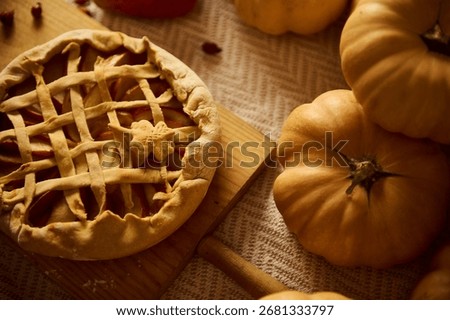 Autumn pumpkin pie on a rustic board beside pumpkins captures harvest warmth, family gathering, and Thanksgiving mood.