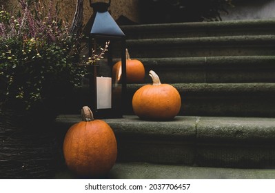 Autumn pumpkins decorated in front door on the steps. Halloween decorations outside. - Shutterstock ID 2037706457