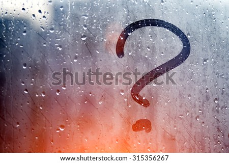 Autumn rain, the inscription on the sweaty glass - question mark