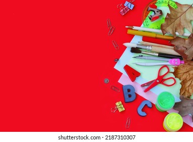 autumn red background with school stationery, back to school concept, knowledge day theme