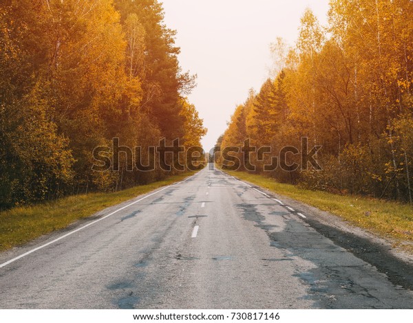 Autumn road car . Terrible pavement on the road in\
rural areas . Russian\
roads