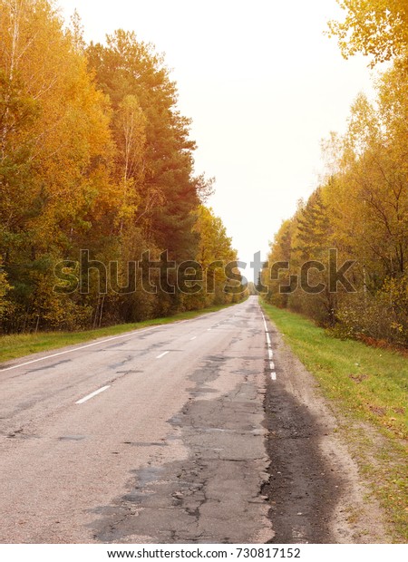 Autumn road car . Terrible pavement on the road in\
rural areas . Russian\
roads