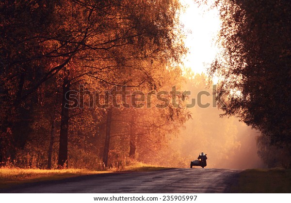 Autumn road\
sunset, the rays of light, the\
journey