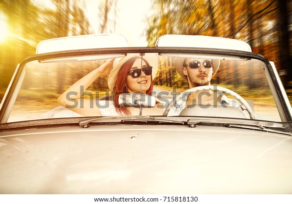 autumn road and two\
lovers in cabriolet 
