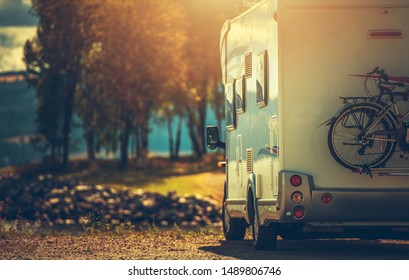 Autumn RV Camping. Modern Camper Van During Late Sunny Fall Afternoon. Scenic RV Park.