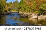 Autumn at Sandy River - A colorful Autumn morning view of a rocky section of Sandy River at Madrid, Maine, USA.