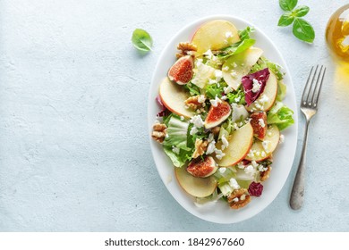 Autumn Seasonal Salad With Apples, Figs And Cheese Served On Plate. View From Above 