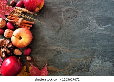 Autumn Side Border Of Apples, Fall Foods And Decor On A Dark Stone Background With Copy Space