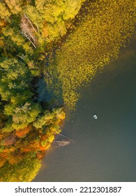 Autumn. A Small Boat With A Fisherman On The Lake. View From Above.