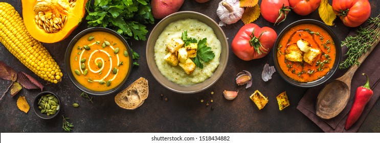 Autumn soups. Set of various seasonal vegetable soups and organic ingredients on dark background, top view, banner. Homemade colourful seasonal vegan soups. - Shutterstock ID 1518434882