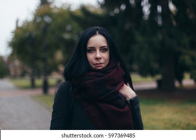 Autumn spring portrait brunette young woman girl, big blue eyes, burgundy scarf, cold weather