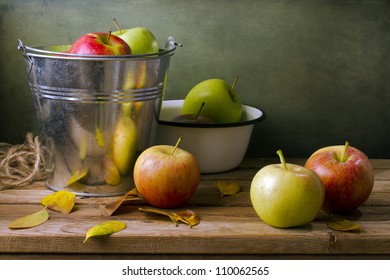 Autumn Still Life With Apples, Leaves And Metal Bucket