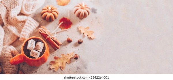 Autumn still life. Cocoa mug and marshmallow, pumpkin candles, knitted sweater, cinnamon sticks and autumn leaves. Top view, flat lay. Banner for web site - Powered by Shutterstock