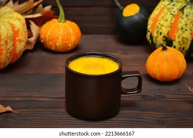 autumn still life with a cup of golden milk and pumpkins - Shutterstock ID 2213666167