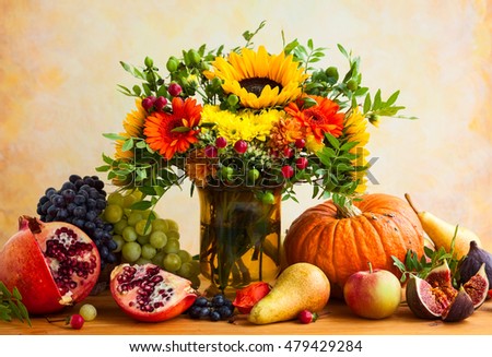 Autumn still life with flowers, pumpkin and fruits
