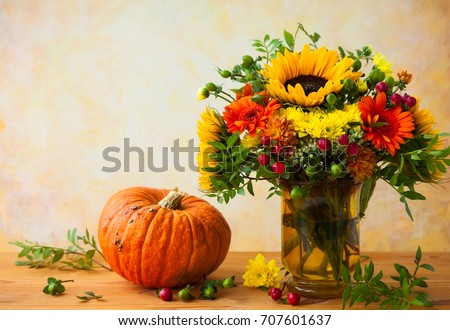Autumn still life with flowers and pumpkin