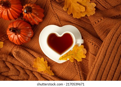 Autumn Still Life. Oak Leaves, Heart Cup On Knitted Scarf Or Plaid. Ceramic Pumpkin - Halloween Home Decor, Concept Of Love Fall Season, Warm, Cozy, Rustic Style Home Decor