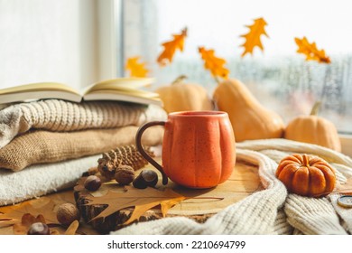 Autumn still life on the windowsill, a cup of tea, candles, pumpkins, leaves, thanksgiving house interior. - Powered by Shutterstock