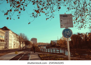 Autumn stroll along the bike path in Strasbourg, France, showcasing vibrant foliage and serene waters - Powered by Shutterstock