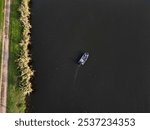 autumn sunny day by the river for fishing. a floating boat sails across the river and the other bank. landing craft. advertisement for fishing equipment. colorful leaves of trees in the alley