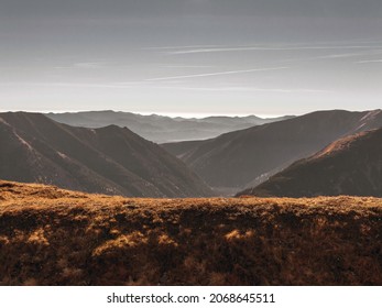 Autumn Sunny Mountain Scenery. Mountainside Covered by Red Grass. Evening Sky. Late Fall. Sunset in the Mountains, Poland. Panoramic View of the Slovak Tatra Mountains