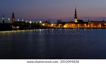 Autumn sunrise in Riga over the Daugava river against the background of Peter's Cathedral