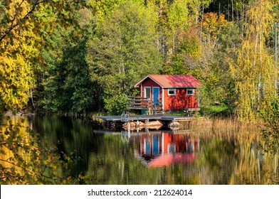 Autumn in Sweden - traditional red little cabin at a lake  - Powered by Shutterstock