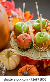 Autumn Table Scape Of Gourds, Caramel Apples And Fall Foliage.