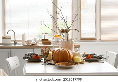 Autumn table setting with pumpkins in kitchen