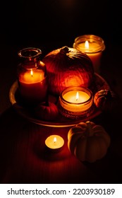 Autumn Thanksgiving Home Decor With Pumpkins And Burning Candles On Table. Dark Moody Banner Decorations With Pumpkin And Candles