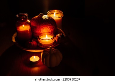 Autumn Thanksgiving Home Decor With Pumpkins And Burning Candles On Table. Dark Moody Banner Decorations With Pumpkin And Candles