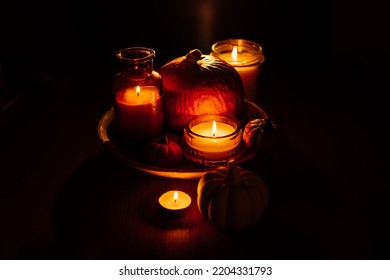 Autumn Thanksgiving Home Decor With Pumpkins And Burning Candles On Table. Dark Moody Banner Decorations With Pumpkin And Candles