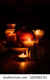 Autumn Thanksgiving Home Decor With Pumpkins And Burning Candles On Table. Dark Moody Banner Decorations With Pumpkin And Candles