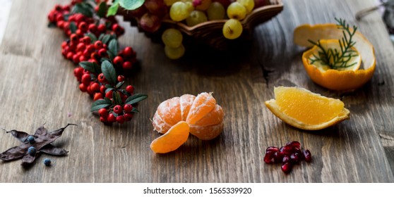 autumn theme still life fruits arrangement on wooden background - Shutterstock ID 1565339920
