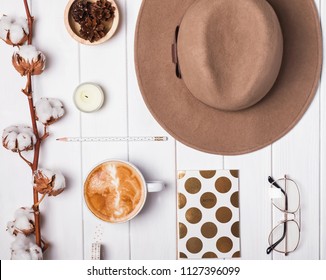 Autumn themed flat ly with felt hat, coffee and cotton branch