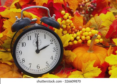 Autumn Time Change, Autumn Leaves And Alarm Clock With A Pumpkin