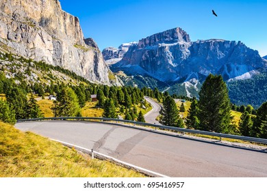 Autumn in the Tirol, Dolomites. Impressive ridge of dolomite rocks. Picturesque highway through the Sella Pass. The concept of ecological and extreme tourism