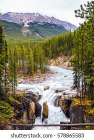 Autumn Trip To Canada. Jasper National Park, Picturesque Waterfall Sanvapta Falls. The Concept Of Extreme And Ecological Tourism