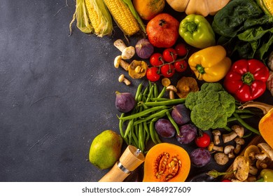 Autumn vegetable preparation dinner background. Food background with organic fresh farm raw veggies, pumpkin, corn, fruits, mushrooms, salad leaves, greenery, Ingredients for cooking with copy space. - Powered by Shutterstock