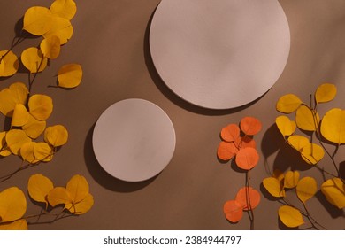 Autumn vibe with colorful dried leaves displayed with two empty podiums. The autumn atmosphere makes us quieter and a bit nostalgic - Powered by Shutterstock