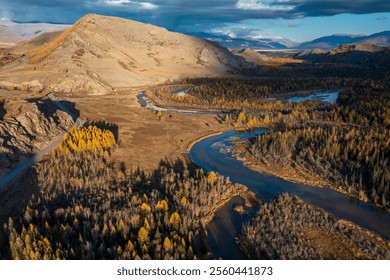 Autumn view of Altai region showcasing a winding river amidst colorful forests and hills. A picturesque and serene natural landscape perfect for exploration and outdoor activities during fall. - Powered by Shutterstock