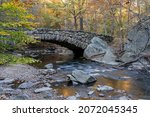 An autumn view of the Boulder Bridge in Rock Creek Park, Washington, DC.  Selective focus.